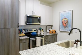 A kitchen with stainless steel appliances and granite counter tops